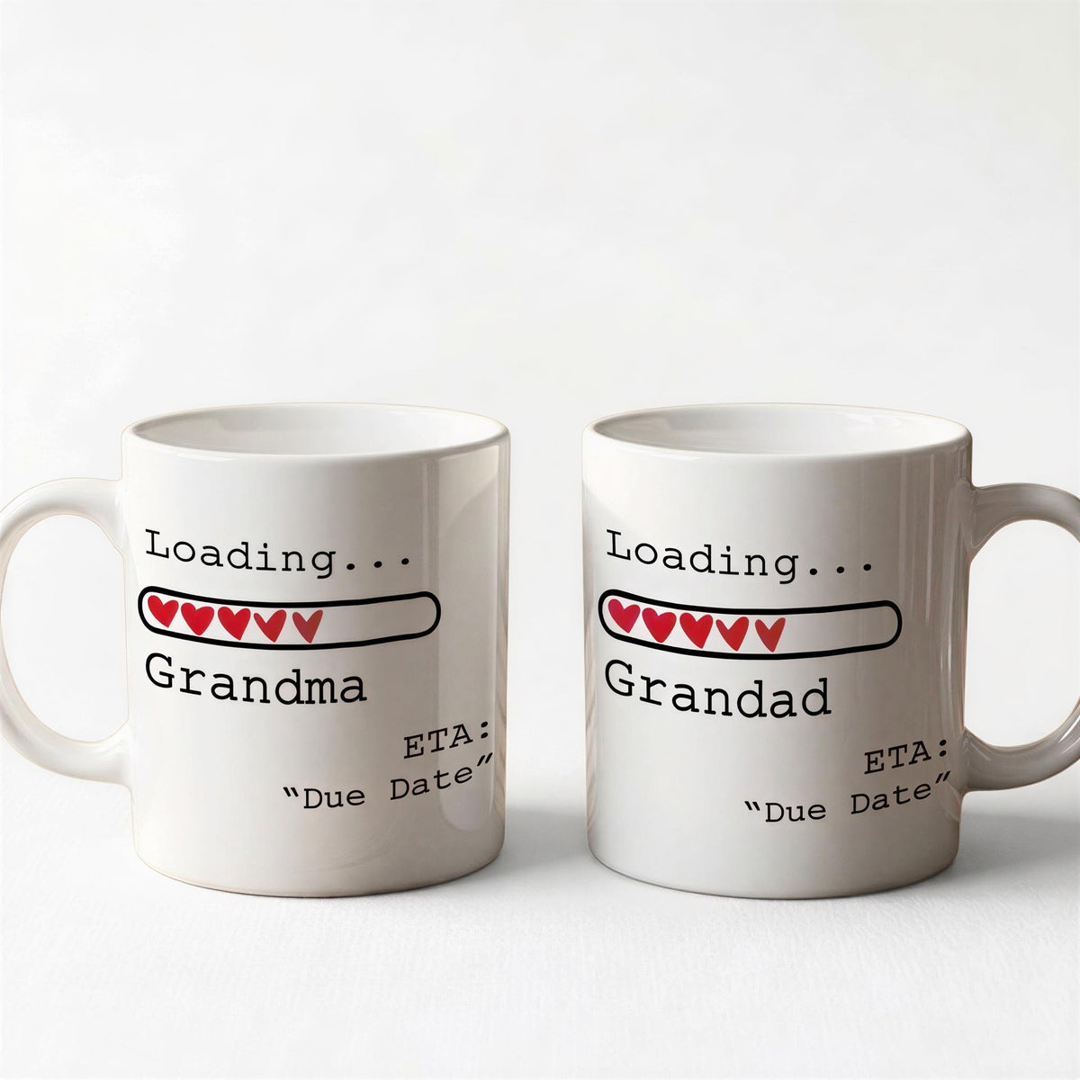 Two white ceramic mugs with text and graphics on them.