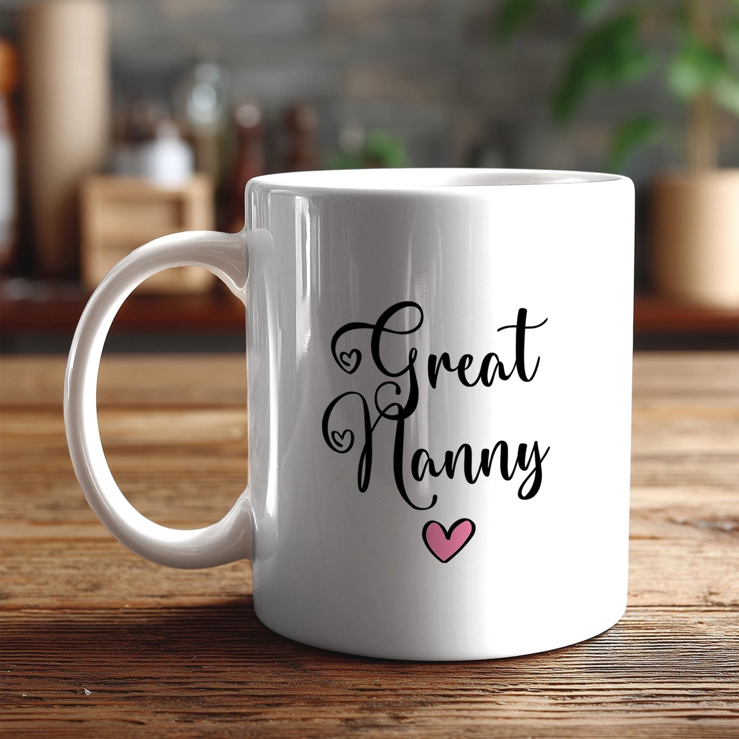 A white ceramic mug with the text "Great Nanny" printed on it, along with a small pink heart symbol.