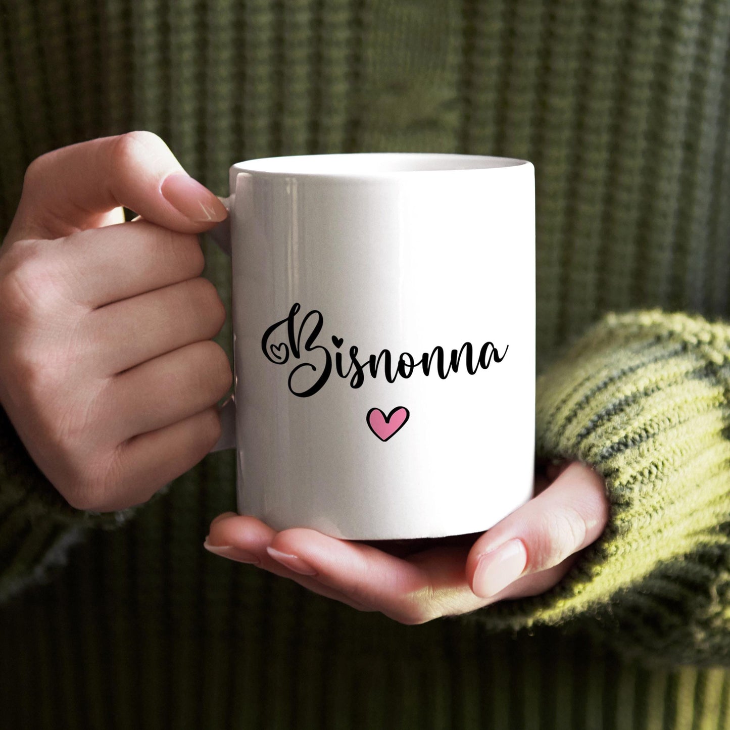 A person's hands holding a white mug with the word "Bisnonna" and a heart symbol printed on it.
