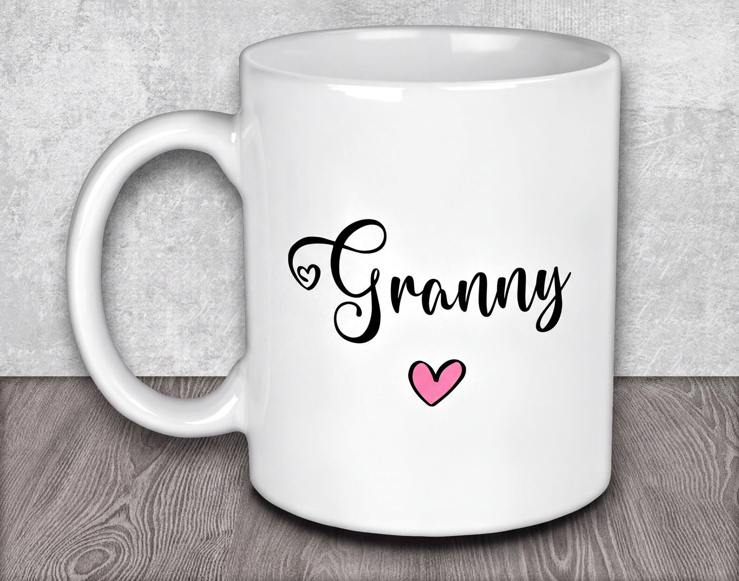 a white coffee mug with a pink heart on it