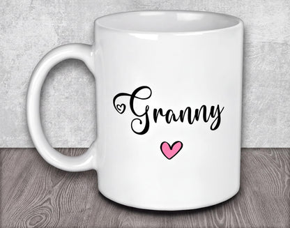 a white coffee mug with a pink heart on it