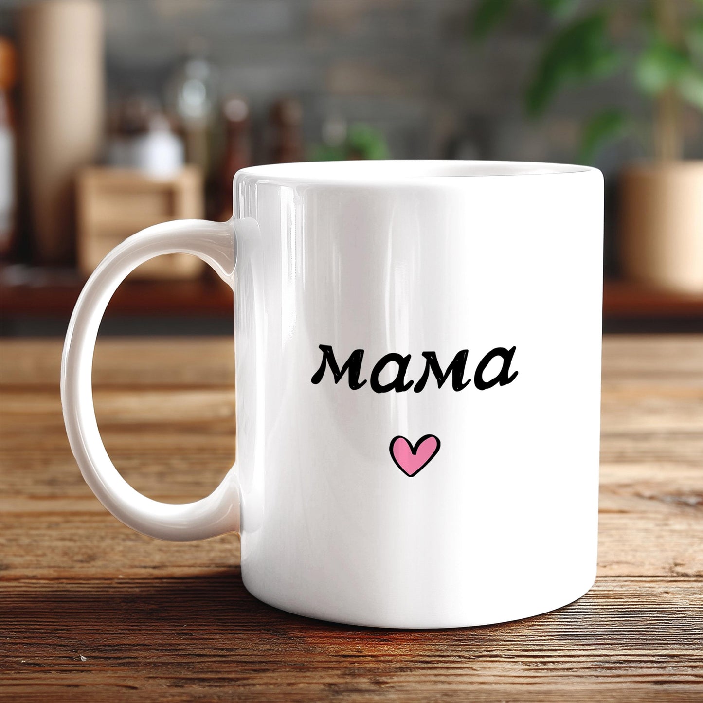 A white ceramic mug with the word "Mama" printed on it, along with a small pink heart symbol, sits on a wooden surface.