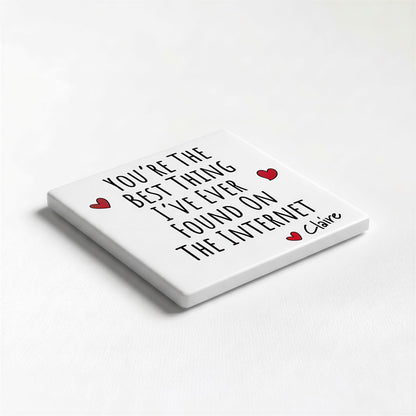 A white square coaster with black text and two red heart symbols.