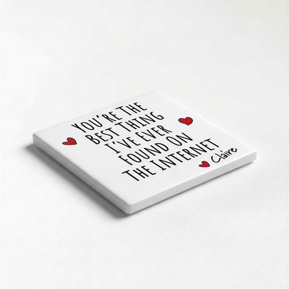 A white square coaster with black text and two red heart symbols.