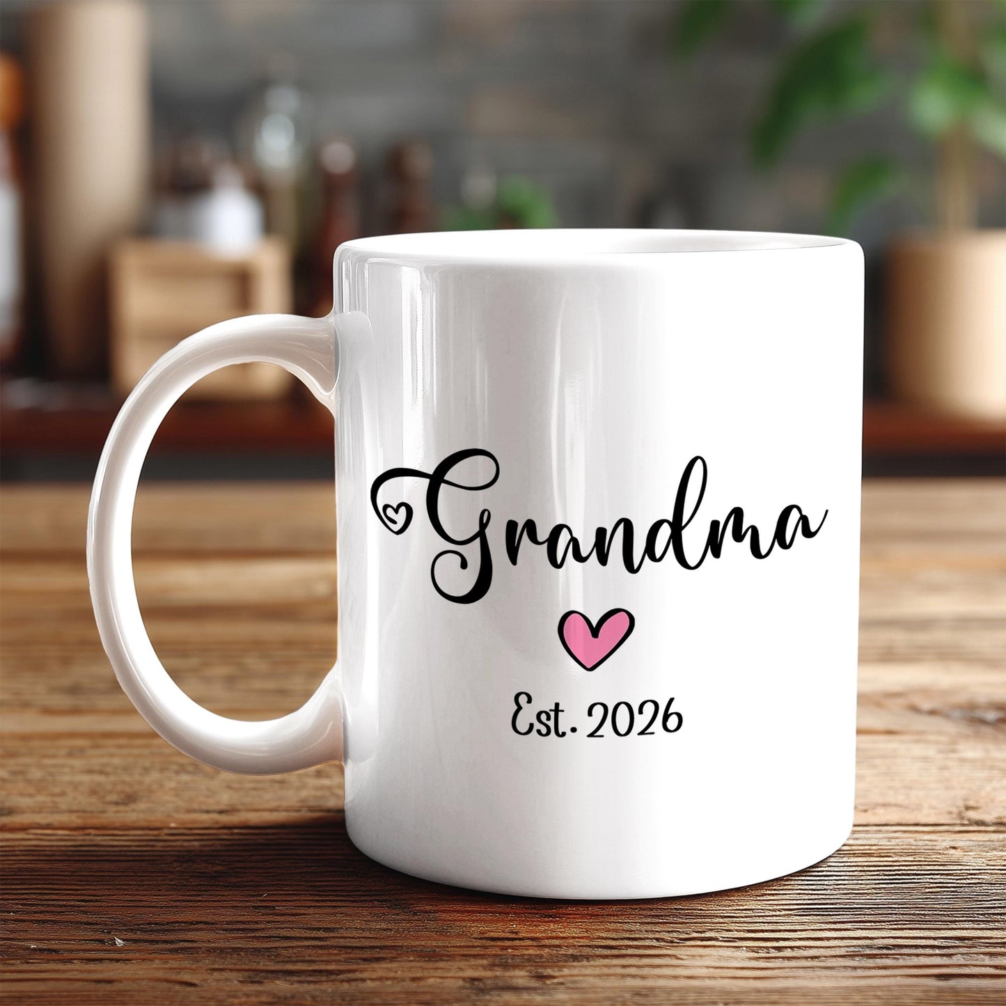 A white ceramic mug with the text "Grandma" and a heart symbol printed on it, along with the year "Est. 2026" below it.