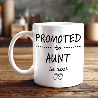 A white ceramic mug with black text and graphics on it, placed on a wooden surface.