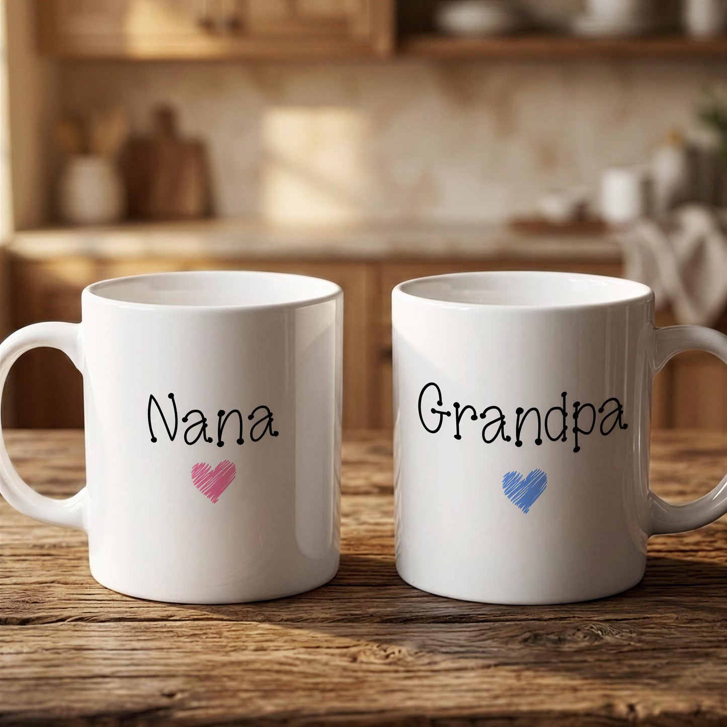 Two white mugs with the names "Nana" and "Grandpa" printed on them, along with a heart symbol, are placed on a wooden surface.