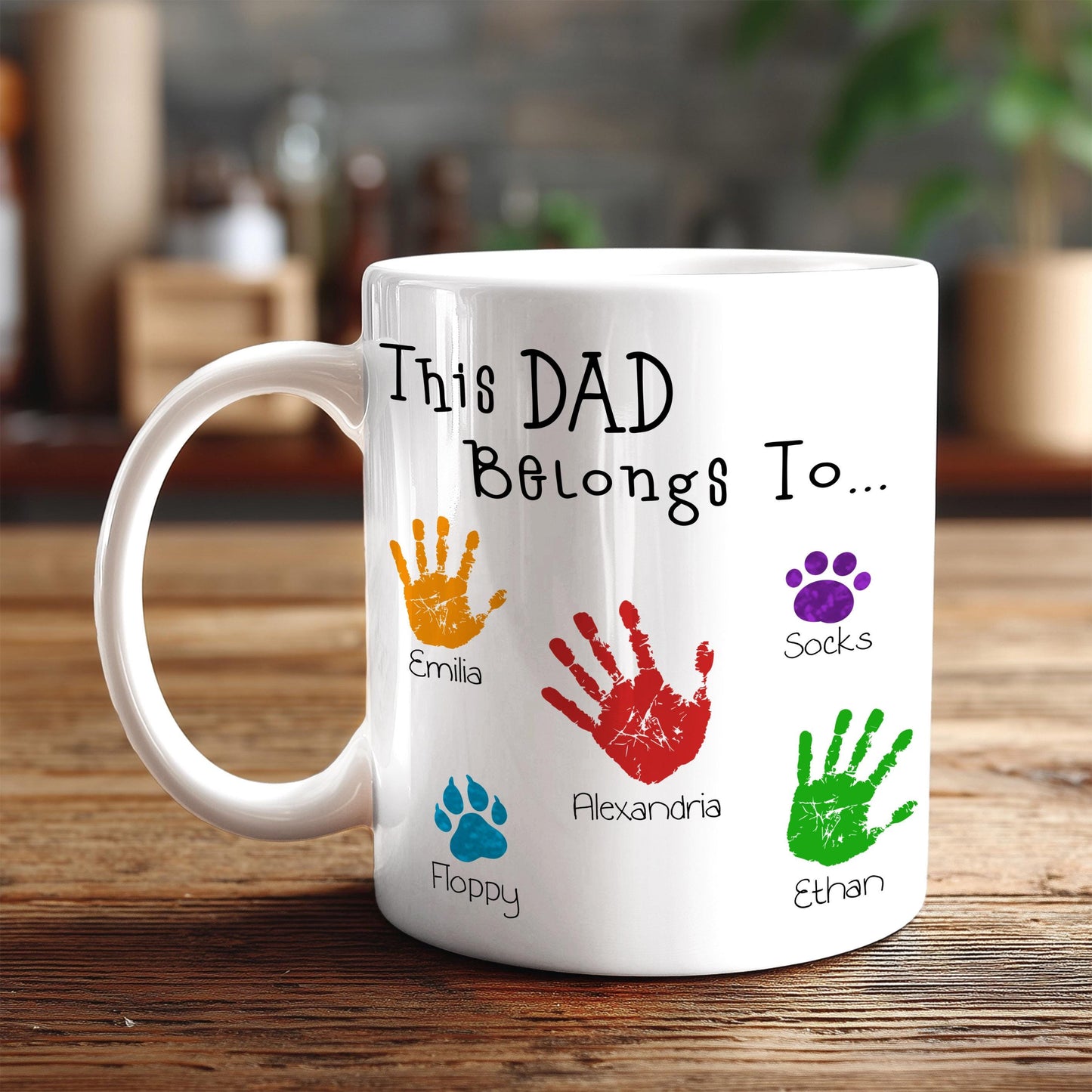 A white mug with a personalized message and handprints of the names of the children of the person who the mug is for.