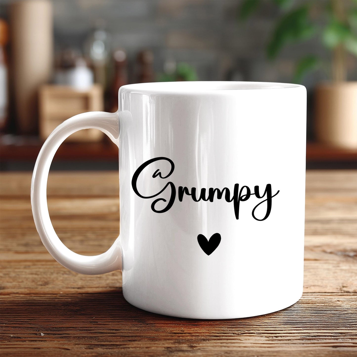 A white ceramic mug with the word "Grumpy" printed on it, along with a small heart symbol.