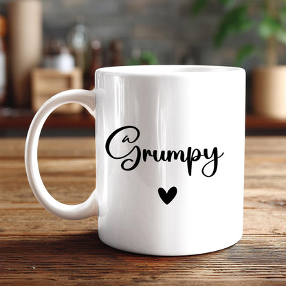 A white ceramic mug with the word "Grumpy" printed on it, along with a small heart symbol.