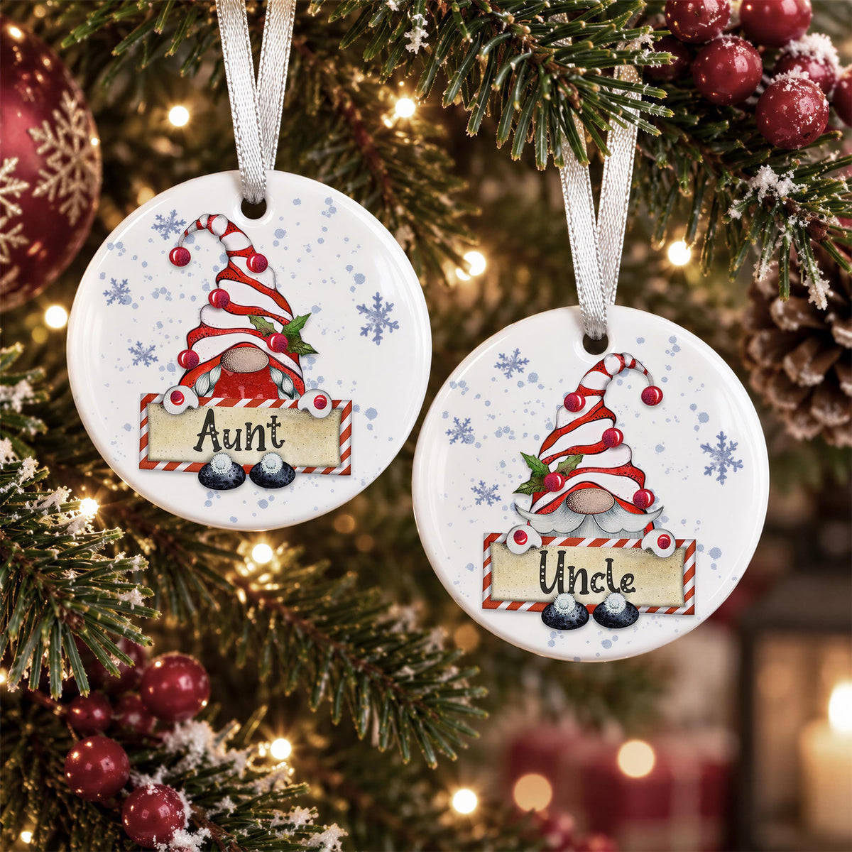 two round ornaments hanging on a Christmas tree, each with a gnome design and the name "Aunt" written on them.