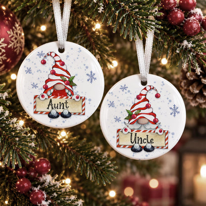 two round ornaments hanging on a Christmas tree, each with a gnome design and the name "Aunt" written on them.