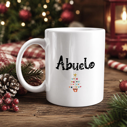 A white mug with the word "Abuelo" printed on it, surrounded by Christmas decorations and ornaments.