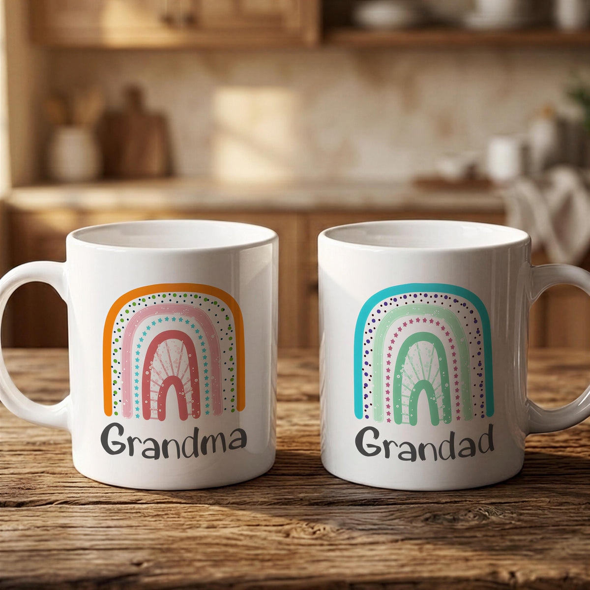 Two white mugs with colorful rainbows and the text "Grandma" and "Grandad" printed on them, placed on a wooden surface.