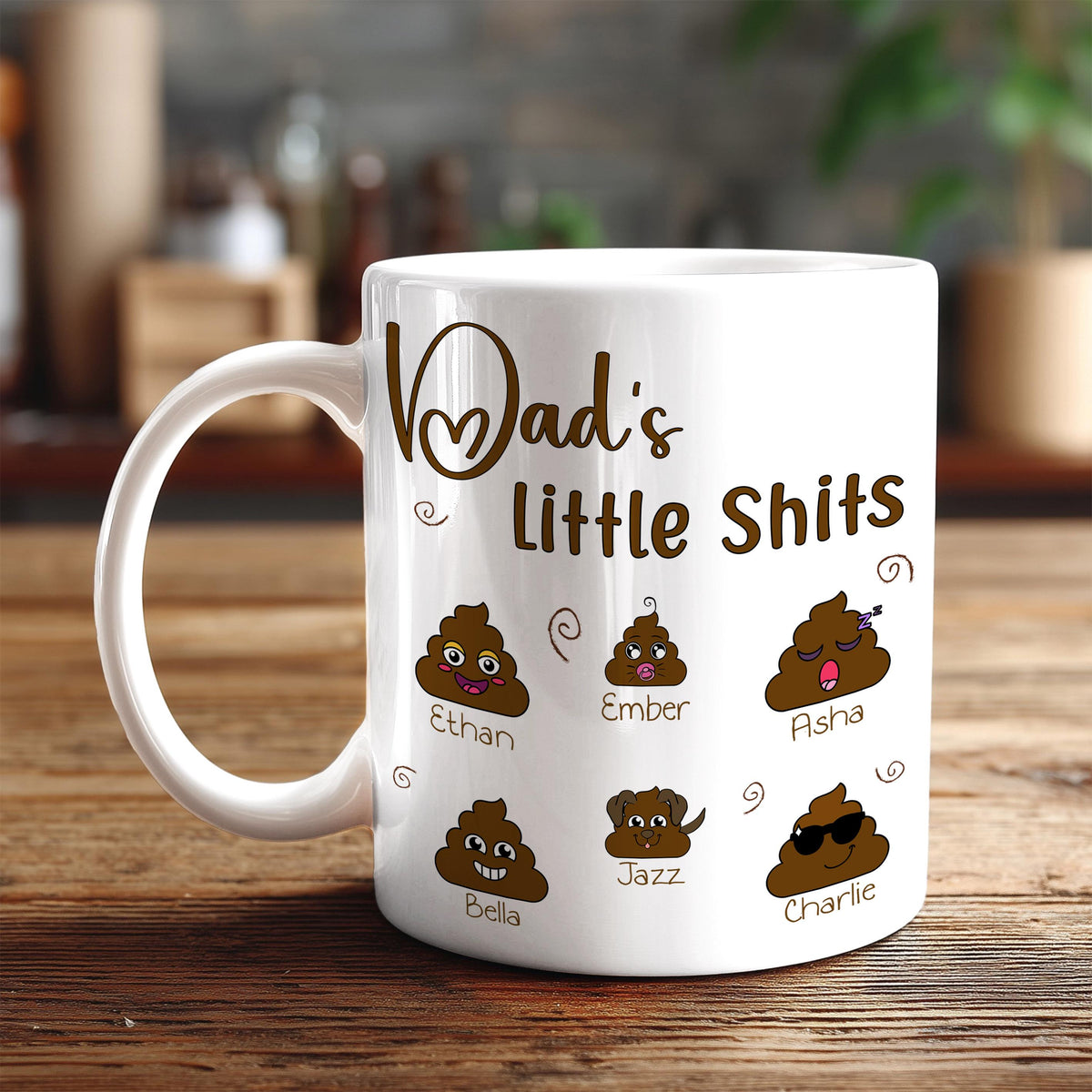 A white coffee mug with a humorous design featuring six cartoon poop faces and the names "Ethan", "Ember", "Asha", "Bella", "Jazz", and "Charlie".