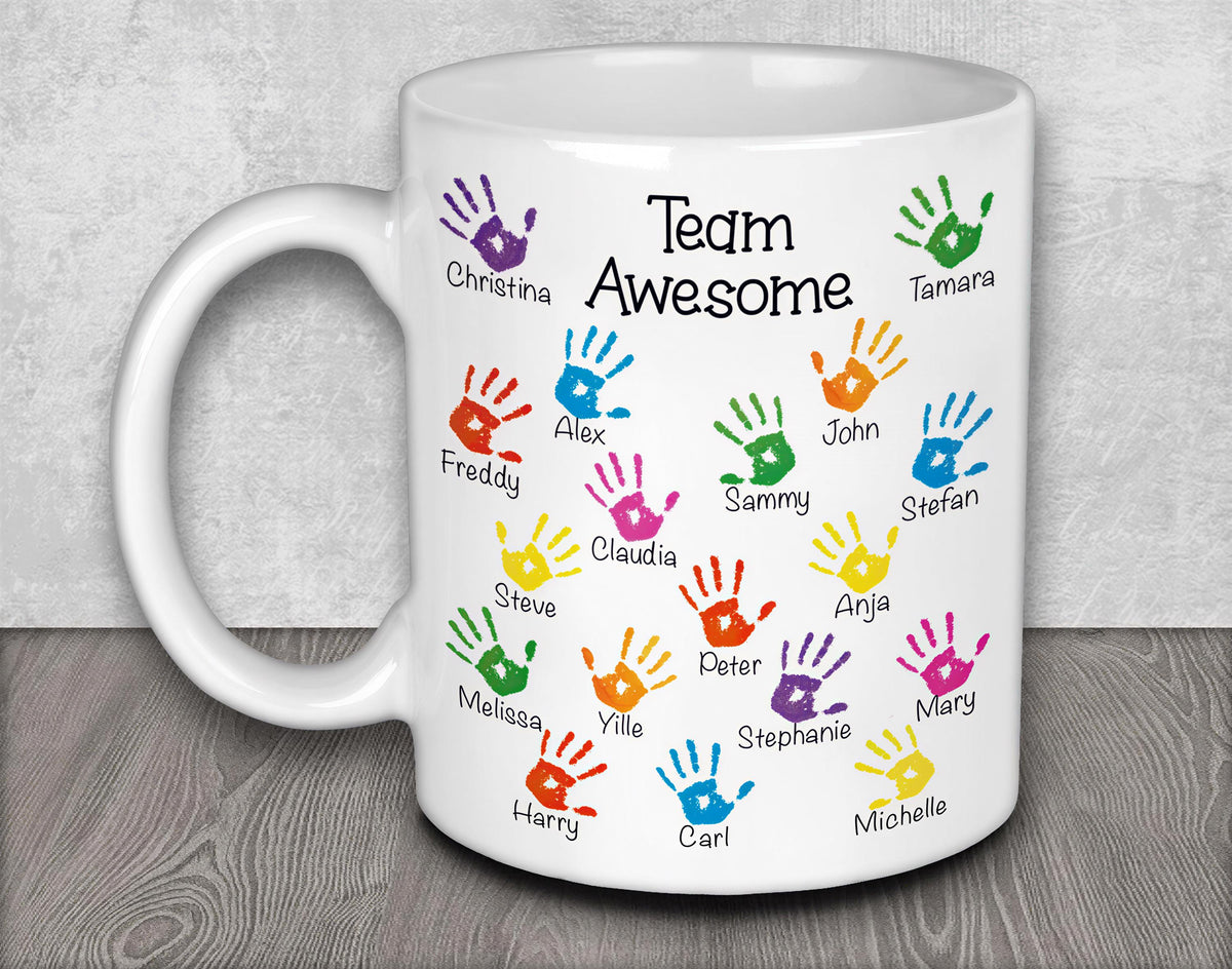 a white coffee mug with colorful hand prints on it