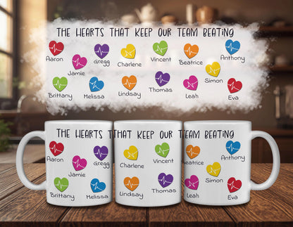 three white mugs with colorful heart-shaped icons and text printed on them. The text on the mugs reads "The hearts that keep our team beating" and lists the names of various people associated with the mugs.