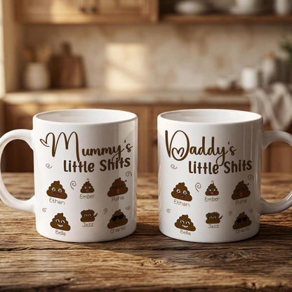 Two white mugs with humorous text and images printed on them, placed on a wooden surface.
